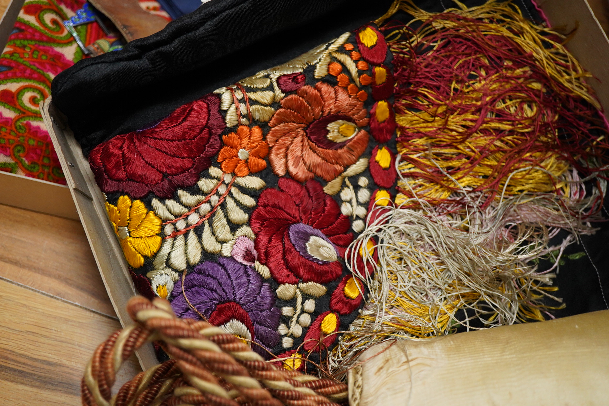 A collection of textiles: a ribbon work hankie and pyjama case, a metalwork collar, a coloured printed shawl, a nurses belt and embroidered belt, an advertising Guggenheim Bilbau hankie etc (10). Hankie case 22cm square.